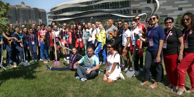 The guests of the World Championships participate in a tree-planting activity